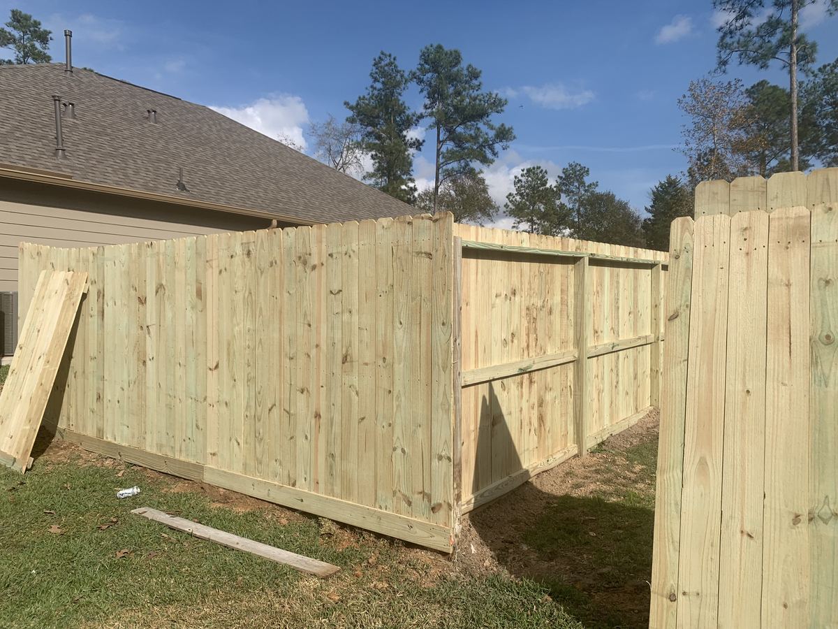 Wood privacy fence installation in a Texas backyard
